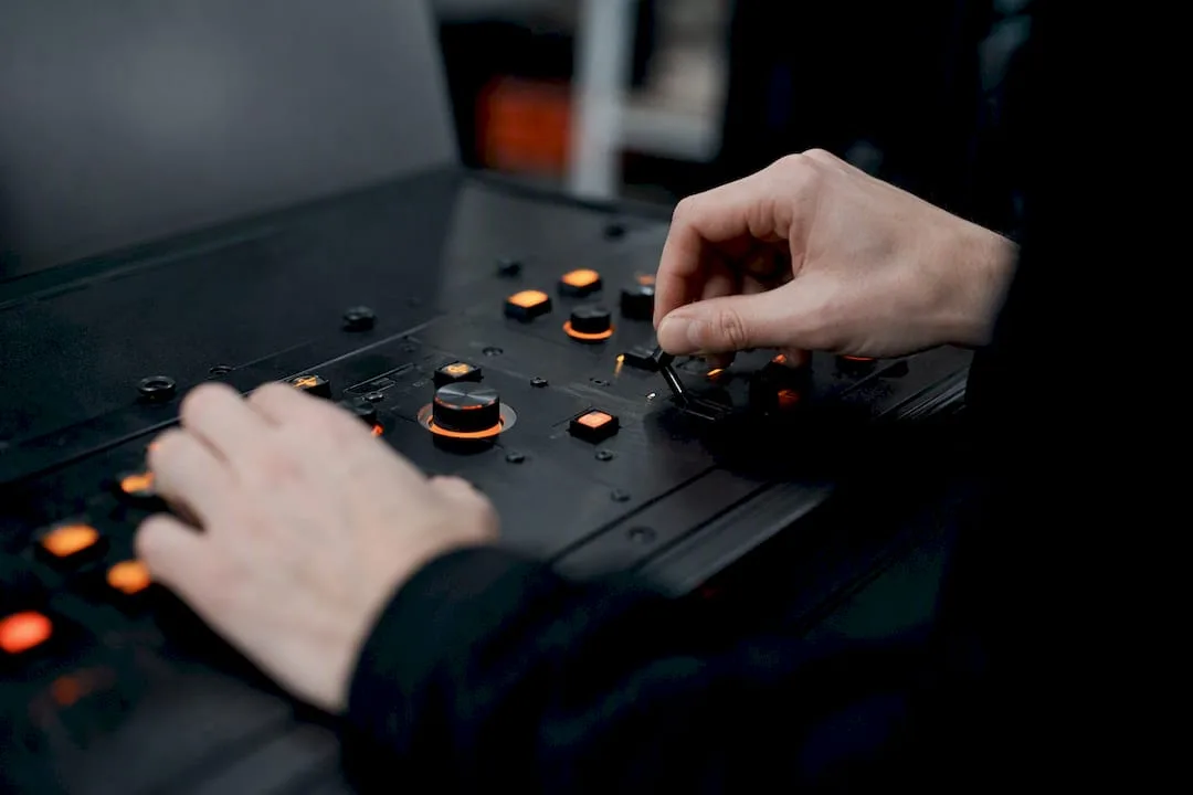 Hands adjusting control dials on governance panel